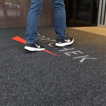 Man walking on Logo Mats